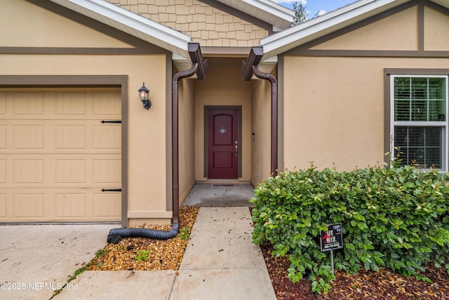 8552 Lake George Cir W, Macclenny, FL 32063 - view of exterior entry featuring stucco siding and an attached garage