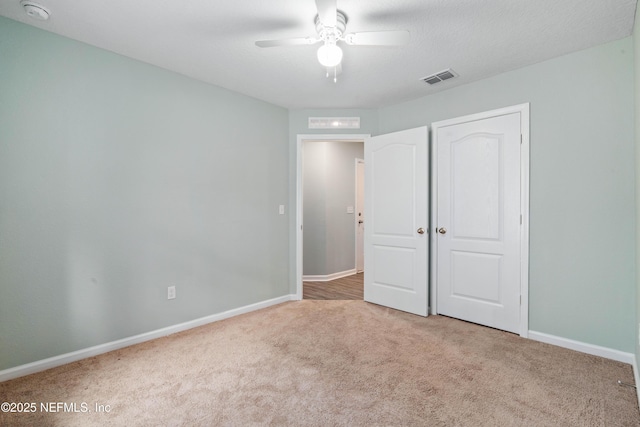 8552 Lake George Cir W, Macclenny, FL 32063 - unfurnished bedroom featuring carpet flooring, baseboards, ceiling fan, and a closet