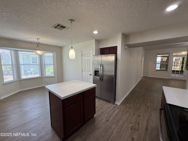 9205 Camshire Dr, Jacksonville, FL 32244 - kitchen featuring stainless steel fridge, open floor plan, dark wood finished floors, a textured ceiling, and black / electric stove