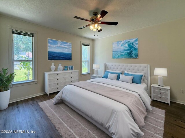 9205 Camshire Dr, Jacksonville, FL 32244 - bedroom featuring a textured ceiling, wood finished floors, baseboards, and ceiling fan