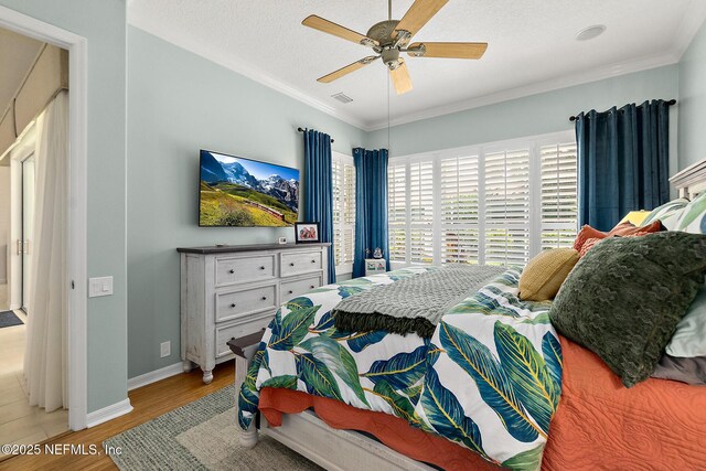 5 Augusta Trl, Palm Coast, FL 32137 - bedroom with light wood-style flooring, ornamental molding, baseboards, ceiling fan, and a textured ceiling