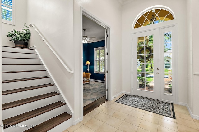 5 Augusta Trl, Palm Coast, FL 32137 - entrance foyer with light tile patterned flooring, ornamental molding, a ceiling fan, stairs, and baseboards