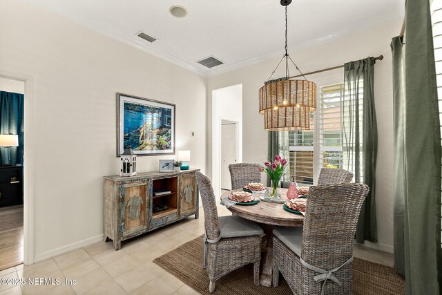 5 Augusta Trl, Palm Coast, FL 32137 - dining space featuring a chandelier, ornamental molding, light tile patterned floors, and baseboards