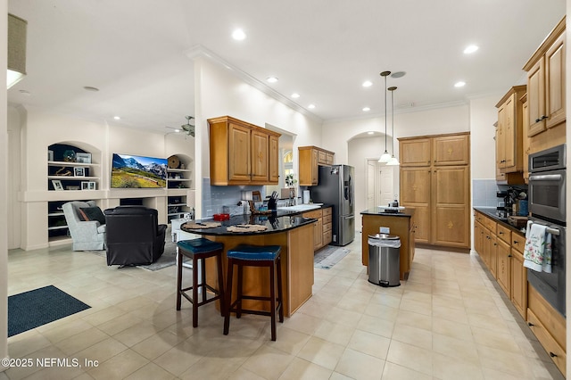 5 Augusta Trl, Palm Coast, FL 32137 - kitchen with stainless steel appliances, dark countertops, open floor plan, a center island, and a ceiling fan