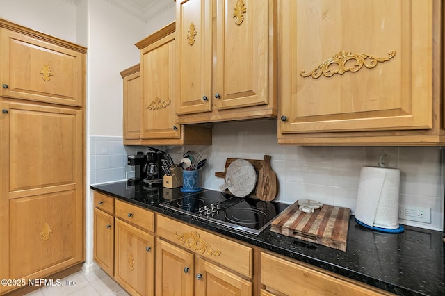 5 Augusta Trl, Palm Coast, FL 32137 - kitchen with black electric cooktop, backsplash, crown molding, dark stone counters, and light tile patterned flooring