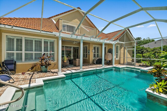 5 Augusta Trl, Palm Coast, FL 32137 - back of property featuring a balcony, a tiled roof, stucco siding, a patio area, and an outdoor pool