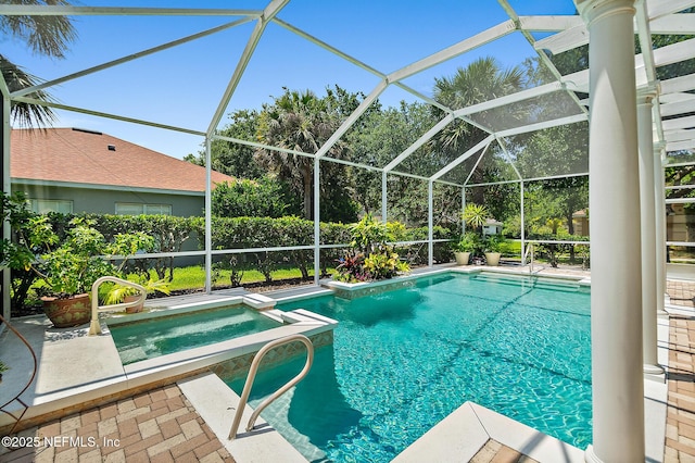 5 Augusta Trl, Palm Coast, FL 32137 - view of swimming pool with a patio area, a pool with connected hot tub, and glass enclosure