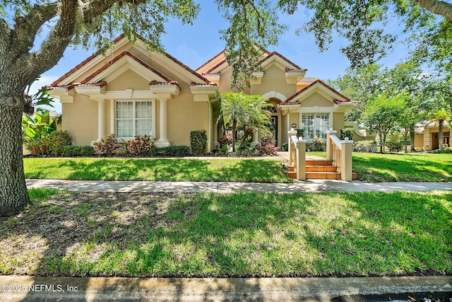 5 Augusta Trl, Palm Coast, FL 32137 - mediterranean / spanish home featuring stucco siding, a front yard, and french doors