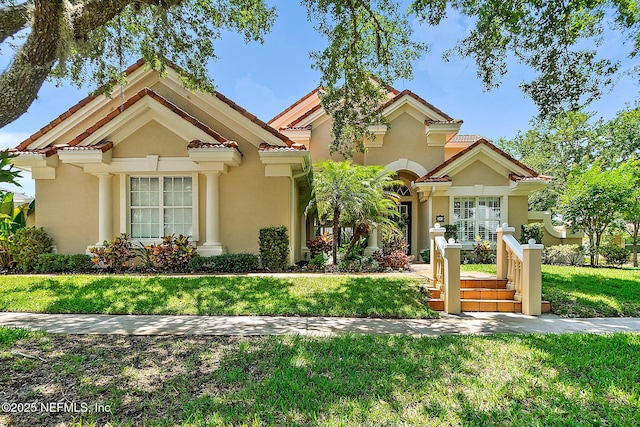 5 Augusta Trl, Palm Coast, FL 32137 - mediterranean / spanish home featuring stucco siding, a front lawn, and a tile roof