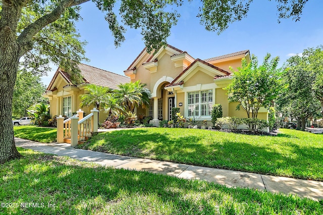 5 Augusta Trl, Palm Coast, FL 32137 - mediterranean / spanish house featuring stucco siding, a front yard, and a tile roof