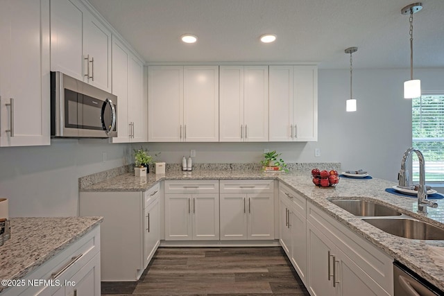 12252 Lyons St, Jacksonville, FL 32224 - kitchen with appliances with stainless steel finishes, a sink, dark wood-style flooring, white cabinets, and recessed lighting