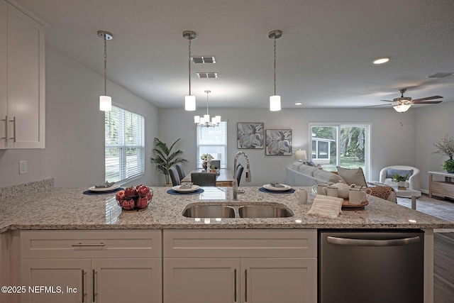 12252 Lyons St, Jacksonville, FL 32224 - kitchen featuring stainless steel dishwasher, a sink, open floor plan, white cabinets, and light stone counters