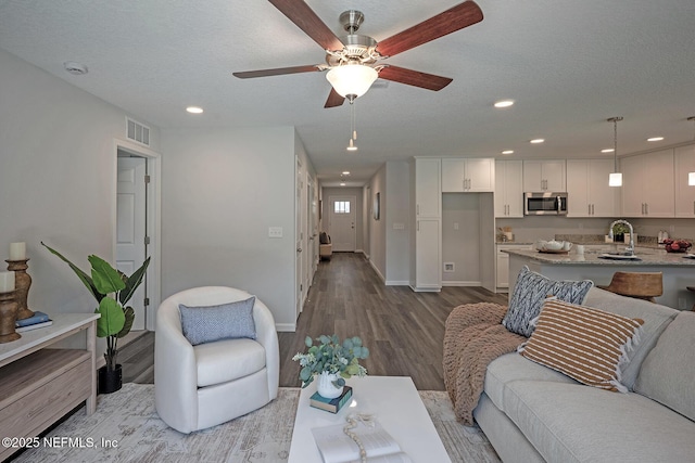 12252 Lyons St, Jacksonville, FL 32224 - living area featuring wood finished floors, ceiling fan, recessed lighting, and baseboards