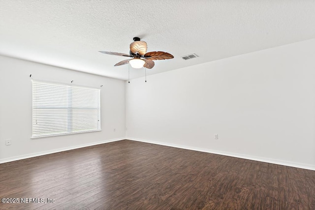 65074 Mossy Creek Ln, Yulee, FL 32097 - spare room featuring a ceiling fan, dark wood-type flooring, baseboards, and a textured ceiling