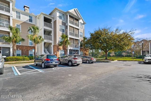 11251 Campfield Dr Unit 4107, Jacksonville, FL 32256 - view of apartment building / complex featuring uncovered parking