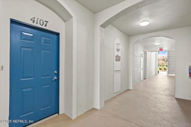 11251 Campfield Dr Unit 4107, Jacksonville, FL 32256 - entrance foyer with arched walkways, a textured wall, and a textured ceiling