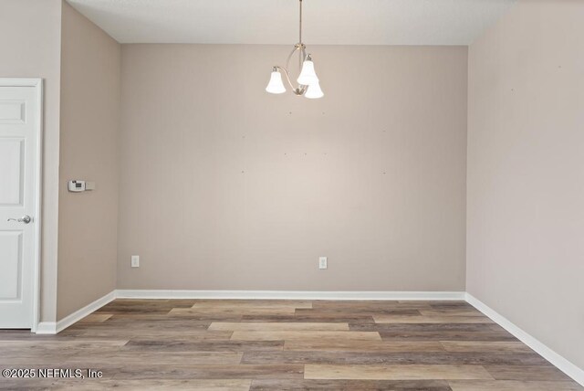 11251 Campfield Dr Unit 4107, Jacksonville, FL 32256 - empty room featuring a chandelier, wood finished floors, and baseboards
