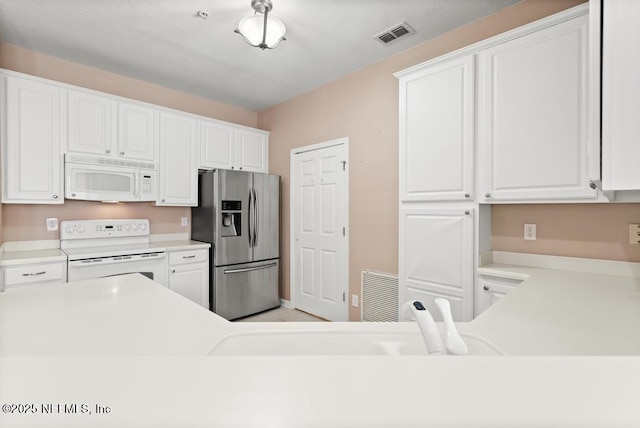 11251 Campfield Dr Unit 4107, Jacksonville, FL 32256 - kitchen featuring white appliances, white cabinetry, and light countertops