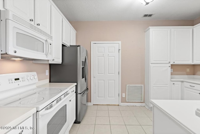 11251 Campfield Dr Unit 4107, Jacksonville, FL 32256 - kitchen with white appliances, white cabinetry, light countertops, and light tile patterned floors