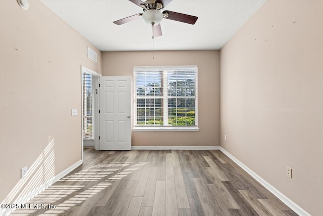 11251 Campfield Dr Unit 4107, Jacksonville, FL 32256 - spare room with wood finished floors, a ceiling fan, baseboards, and a smoke detector