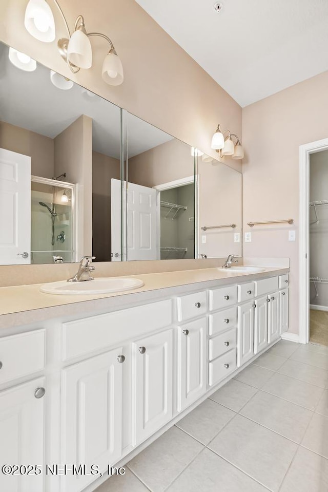 11251 Campfield Dr Unit 4107, Jacksonville, FL 32256 - full bath featuring a walk in closet, tile patterned flooring, double vanity, and a stall shower