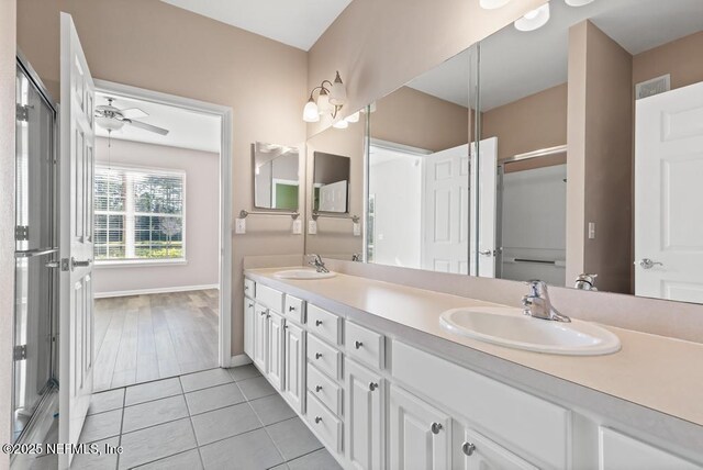 11251 Campfield Dr Unit 4107, Jacksonville, FL 32256 - bathroom with double vanity, tile patterned floors, baseboards, and ceiling fan