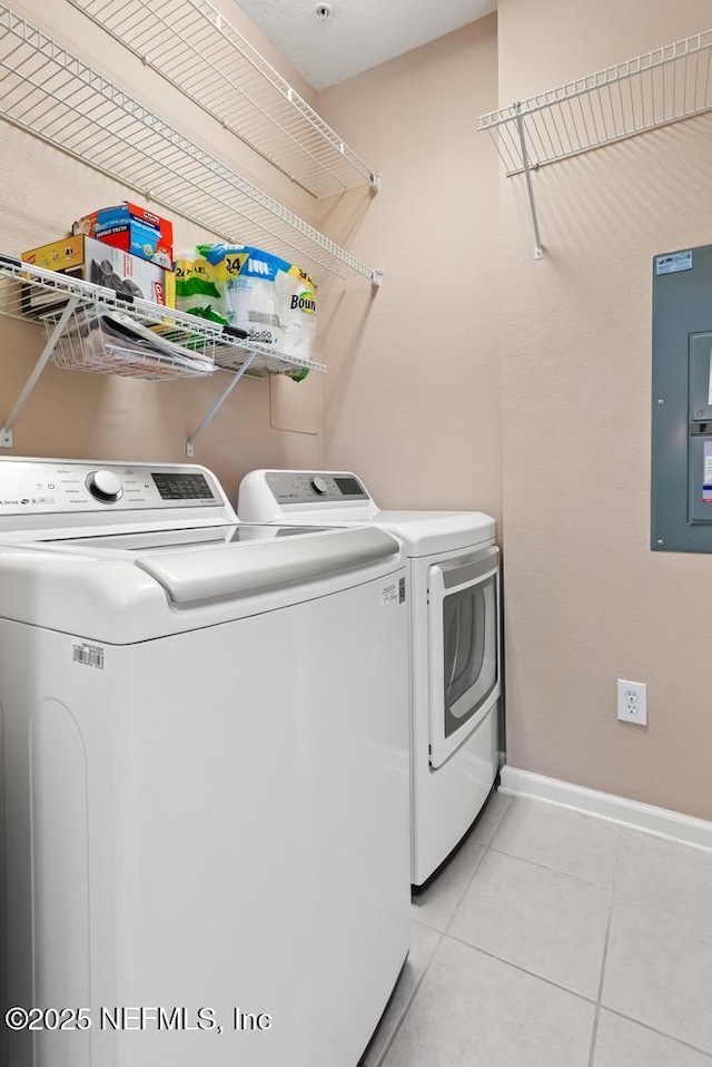 11251 Campfield Dr Unit 4107, Jacksonville, FL 32256 - washroom featuring washing machine and dryer, light tile patterned floors, electric panel, and baseboards