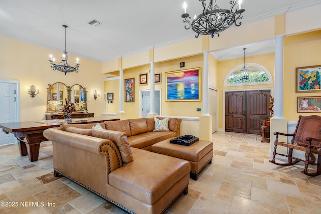 8 Rue Renoir, Palm Coast, FL 32137 - living room with a chandelier, ornamental molding, stone tile flooring, ornate columns, and a towering ceiling