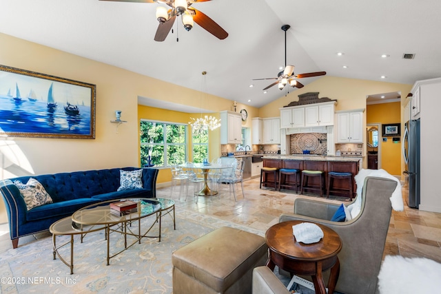 8 Rue Renoir, Palm Coast, FL 32137 - living room featuring a ceiling fan, vaulted ceiling, light stone finish flooring, recessed lighting, and baseboards