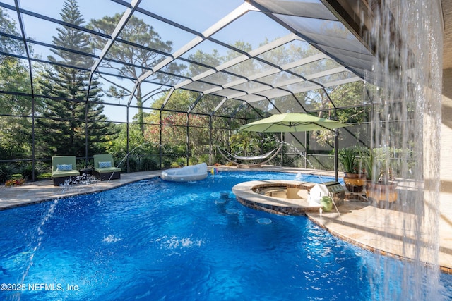 8 Rue Renoir, Palm Coast, FL 32137 - view of swimming pool featuring a pool with connected hot tub, a patio, and glass enclosure