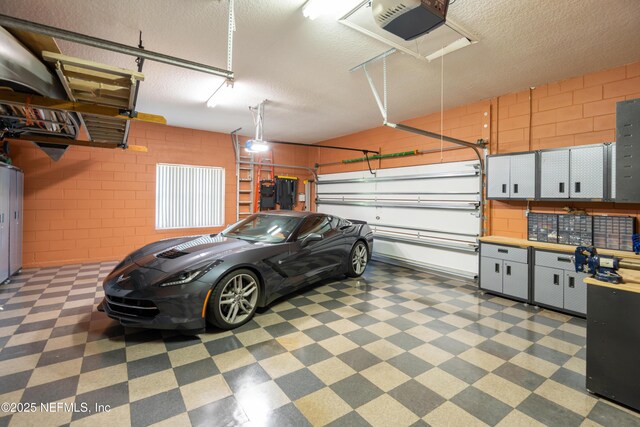 8 Rue Renoir, Palm Coast, FL 32137 - garage with a garage door opener and concrete block wall