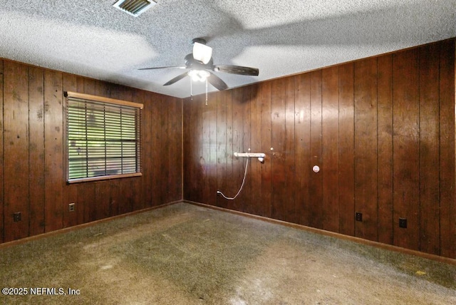 5342 Hickson Rd, Jacksonville, FL 32207 - unfurnished room with a ceiling fan, carpet flooring, wooden walls, and a textured ceiling