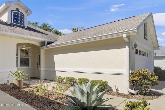 1141 Glengad, Ormond Beach, FL 32174 - view of side of home featuring stucco siding, a garage, and a shingled roof
