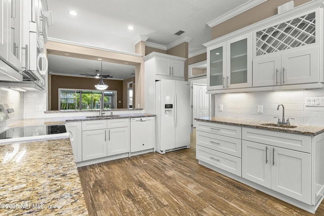 1141 Glengad, Ormond Beach, FL 32174 - kitchen featuring white appliances, crown molding, backsplash, glass insert cabinets, and ceiling fan