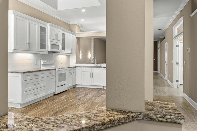 1141 Glengad, Ormond Beach, FL 32174 - kitchen with white appliances, ornamental molding, backsplash, recessed lighting, and light wood-style flooring