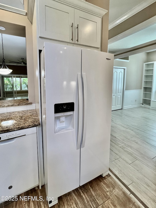 1141 Glengad, Ormond Beach, FL 32174 - kitchen with white appliances, ceiling fan, wood finished floors, dark stone counters, and ornamental molding