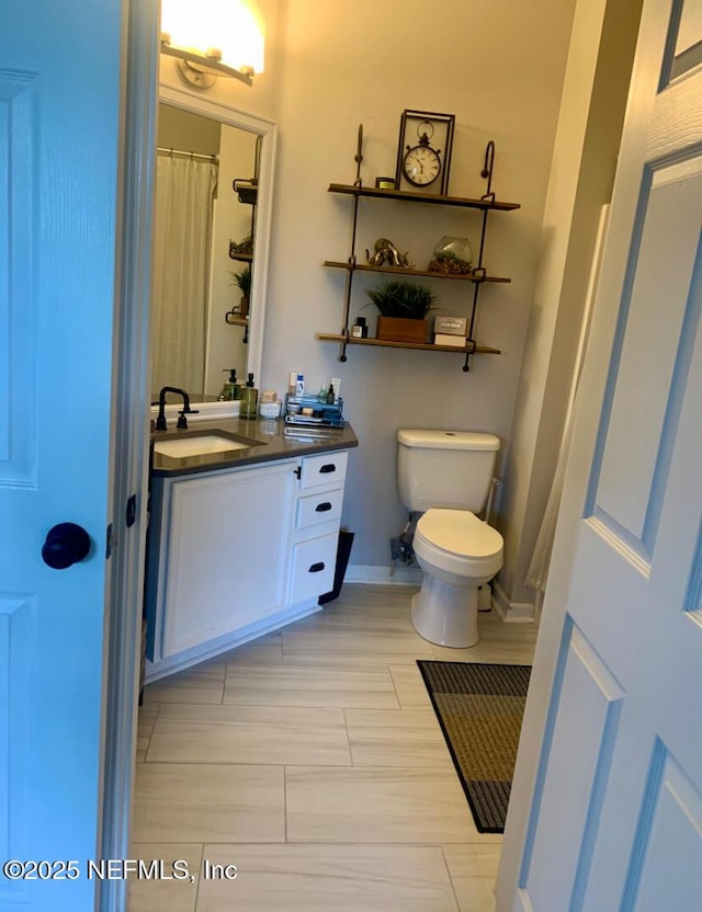 7990 Baymeadows Rd E Unit 926, Jacksonville, FL 32256 - bathroom featuring vanity, toilet, and baseboards