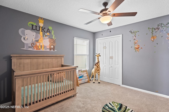 1929 Rock Springs Way, Middleburg, FL 32068 - bedroom featuring carpet, a crib, a textured ceiling, a closet, and a ceiling fan