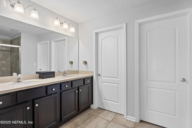 1929 Rock Springs Way, Middleburg, FL 32068 - full bathroom with double vanity, a shower stall, tile patterned floors, and a textured ceiling
