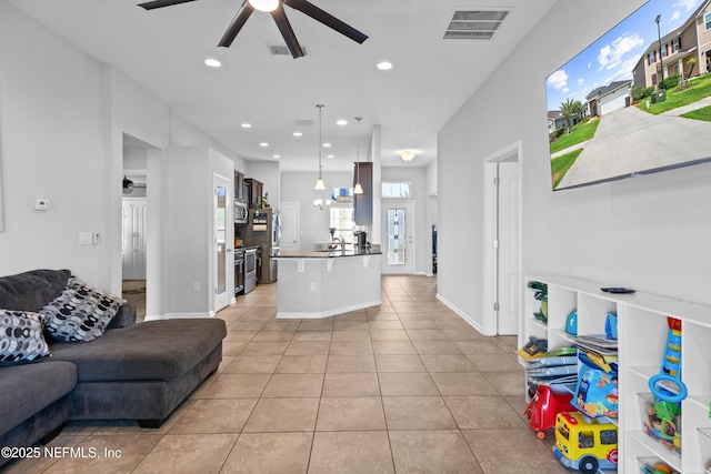 1929 Rock Springs Way, Middleburg, FL 32068 - living room with ceiling fan, light tile patterned flooring, recessed lighting, and baseboards