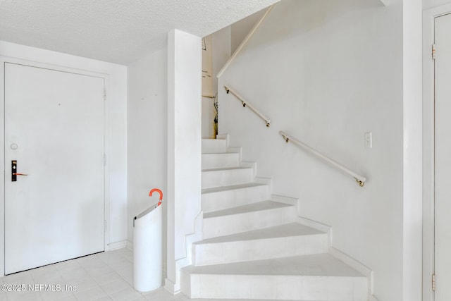 3115 Harbor Dr, Saint Augustine, FL 32084 - stairway featuring tile patterned flooring and a textured ceiling