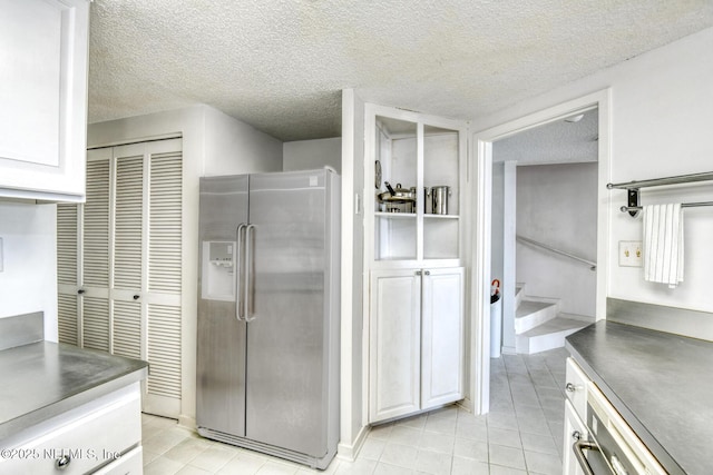 3115 Harbor Dr, Saint Augustine, FL 32084 - bathroom featuring tile patterned floors, a textured ceiling, vanity, and a stall shower