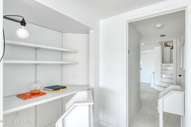 3115 Harbor Dr, Saint Augustine, FL 32084 - interior space featuring light countertops, a textured ceiling, light tile patterned floors, open shelves, and white cabinets
