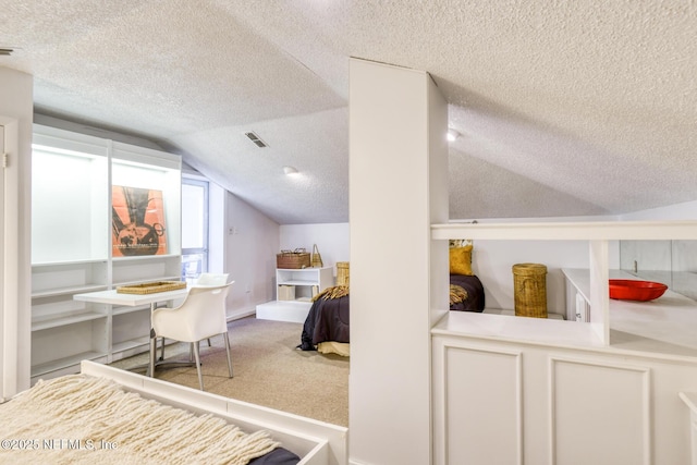 3115 Harbor Dr, Saint Augustine, FL 32084 - carpeted bedroom with lofted ceiling and a textured ceiling