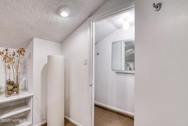 3115 Harbor Dr, Saint Augustine, FL 32084 - corridor featuring carpet, vaulted ceiling, and a textured ceiling