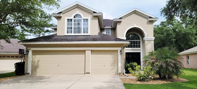 1691 Canopy Oaks Dr, Orange Park, FL 32065 - traditional-style home with concrete driveway, stucco siding, a garage, and roof with shingles