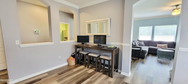 1691 Canopy Oaks Dr, Orange Park, FL 32065 - office featuring arched walkways, ceiling fan, wood finished floors, and crown molding