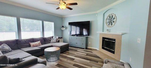 1691 Canopy Oaks Dr, Orange Park, FL 32065 - living area with light wood-type flooring, a fireplace, ceiling fan, ornamental molding, and baseboards