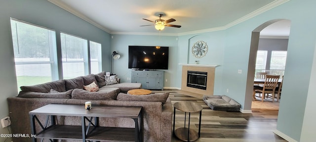1691 Canopy Oaks Dr, Orange Park, FL 32065 - living area with arched walkways, a ceiling fan, wood finished floors, ornamental molding, and baseboards