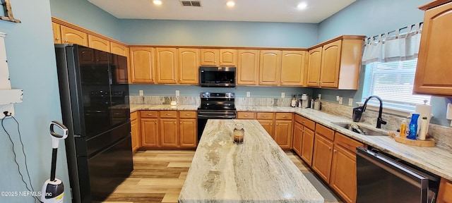 1691 Canopy Oaks Dr, Orange Park, FL 32065 - kitchen with black appliances, a sink, light wood finished floors, a center island, and recessed lighting